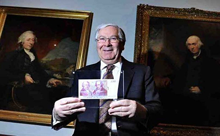 Former Governor of the Bank of England holding a £50 note featuring historic members of the Lunar society